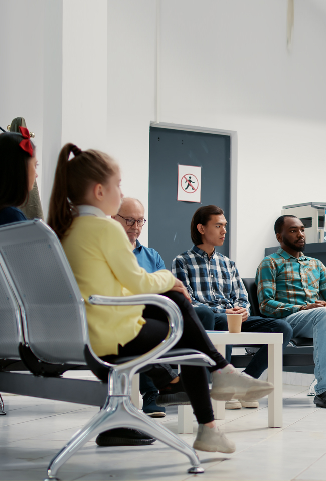 Diverse patients wait calmly in a modern dental office waiting room in Miami.